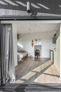 The view of the interior from the terrace. The floors are waterproof laminate and the walls are painted wood siding. 