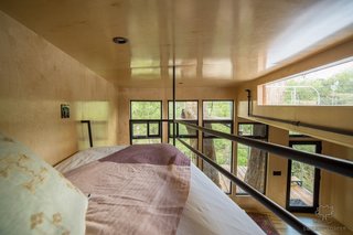 A loft bed above the living area offers an extra sleeping space for a third guest.