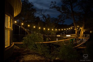A view of the suspension bridge illuminated at night.
