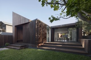 The home is clad in sustainably sourced spotted gum. A natural material palette is used throughout.