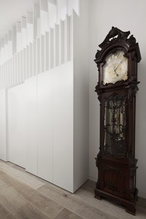 A glimpse inside the entry hallway anchored by a grandfather clock.
