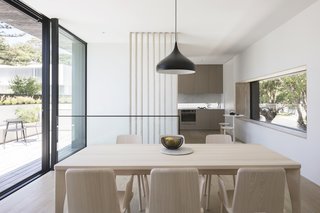 A Sipa Fold Rectangular Table and Sipa armchairs in natural ash outfit the dining area.