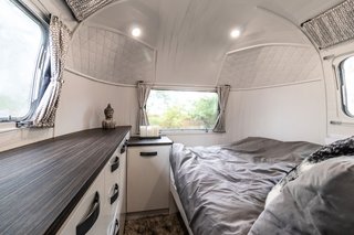 Annie and Martin's bedroom in the rear is furnished with a double bed that leans towards the bathroom wall to provide full outside views when sitting.