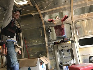 Annie and Martin in mid-restoration. The couple purchased the secondhand Airstream after spending two years at sea in a boat with their three children.