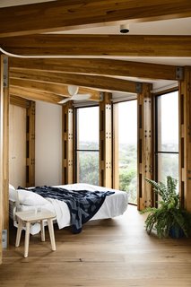 A peek inside one of the two bedrooms. Blackbutt strip timber flooring is used throughout the upper level.