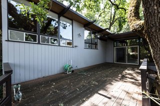 The outdoor deck showed signs of damage from natural weathering over time and lack of maintenance.