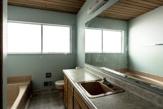While the existing bathroom layout was perfectly usable, dated surface materials were swapped for a more contemporary look.