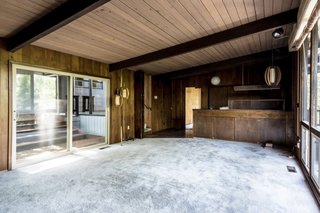 The dated living room was constricted with timber on all sides.