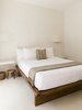 Modern home with Bedroom, Wall Lighting, Bed, Night Stands, and Concrete Floor. The hand-sculpted light sconces are by artist Justin James. Photo 7 of Casa Pueblo Tulum