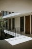 Modern home with Outdoor, Trees, Hanging Lighting, Concrete Patio, Porch, Deck, Vertical Fences, Wall, Metal Fences, Wall, Large Patio, Porch, Deck, and Side Yard. The hotel rooms open up to an open-air atrium filled with light and greenery. Photo 8 of Casa Pueblo Tulum