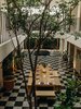 Modern home with Dining Room, Bench, Floor Lighting, Table, and Ceramic Tile Floor. Local flora is brought indoors to inject life into the atrium. The Chaca tree serves as a major focal point. Photo 9 of Casa Pueblo Tulum