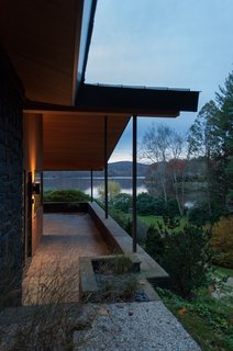 The updated south porch reinforces views of the lake with a more streamlined appearance. The existing siding was in poor condition and replaced with tongue-and-groove red cedar.