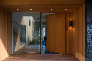 A massive, custom cedar door was installed at the main entry along with a glazed sidelight.