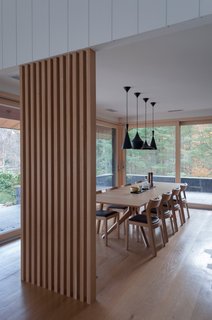 The dining room was opened up to the living room and kitchen for a greater feeling of openness. The dining table set is from the DWR cross collection and is complemented with Tom Dixon pendants to create an intimate feel.