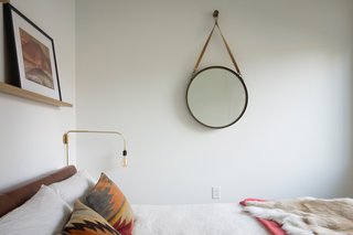 A look inside the third bedroom, located on the west side of the north wing. The hanging mirror is from CB2. All bedding is from Design Within Reach and CB2.