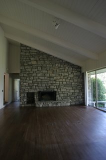 Before: The double-sided fireplace in the original living room was "visually noisy" and detracted from outdoor views.