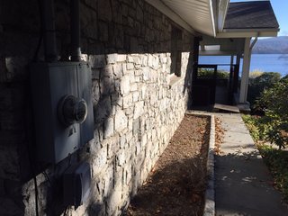 Before: Large structural beams and the visually busy stone walls detracted from the lake view.
