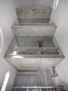 “The section and internal void works as a space where light travels around and produces a very calm sense of interiority. But also, from the rooms, it becomes a sort of interior courtyard,” Zamarbide said. The unfinished concrete slabs contrast with the cement block walls painted white.