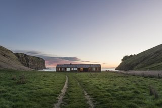 Flanked by hills, Scrubby Bay stretches east to west facing the Pacific Ocean on rocky headland.
