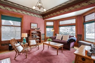 The family room includes a large bay window with original leaded glass and original hardwood floors.