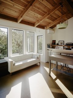 The sun-soaked art studio is elevated into the tree canopy.