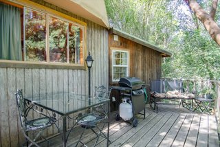 Guests can enjoy a meal out on the deck, which comes with seating, a table, a barbecue grill, and an extra gas burner.