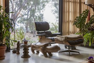 A newly replaced Eames Lounge Chair and Ottoman sit in the living room.