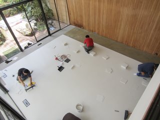 As part of the CMP process, the severely damaged square vinyl-asbestos tiles in the living room were replaced with vinyl-composite tile flooring.