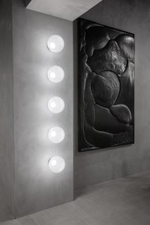 In addition to serving as a restaurant and showroom, The Manzoni can also be used as an art gallery or nightclub. The wall features Tom Dixon's new semitranslucent Opal lights, which are made from tinted white opalescent polycarbonate and include an integrated dimmable custom LED.