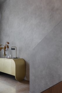 The brass sideboard by Jonathan West matches the other aged brass elements in the apartment.