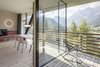 Modern home with Outdoor, Decking Patio, Porch, Deck, Horizontal Fences, Wall, Side Yard, Wood Fences, Wall, and Trees. For energy efficiency, the architects fitted the walls with wood fiber insulation and triple-glazed windows. Photo 7 of Family Resort Rainer