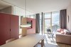 Modern home with Living Room, Chair, Light Hardwood Floor, Pendant Lighting, Rug Floor, Sofa, and Table. The architects focused on natural and locally sourced materials wherever possible, from local larch to the custom-made sofas and rugs woven from local sheep wool by Hermann Kühbacher. The furnishings were mainly custom made and designed by Plasma Studio. Photo 9 of Family Resort Rainer