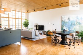 Bathed in natural light thanks to walls of windows on either side, the airy, open-plan living area takes up nearly half of the home's footprint.