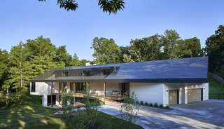 The five-bedroom, seven-bath home includes a basketball court and sport lawn. An existing barn on site was also repurposed into an activity space for the family’s three children.