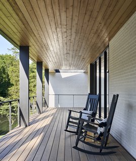 A pair of rocking chairs are perfectly positioned for taking in views of the stream.