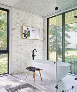 The Victoria + Albert Barcelona tub overlooks views of the outdoors.