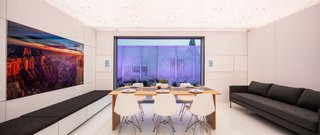 The audiovisual wall features a television that can be used for teleconferencing on the office side (not pictured). It spins around so that it can be used for entertainment in the living room.