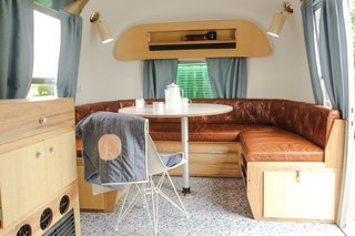The magazine rack originally found on the wall of the Airstream was replicated at the bottom of the dining banquette.