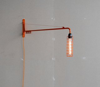 Abloh redesigned Prouvé's 1942 Petite Potence lamp with an LED bulb in an oblong cage and finished it in orange lacquer. Abloh's version is available in a numbered edition of 300 pieces.