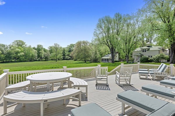 The spacious porch with beadboard detailing overlooks the lawn. 