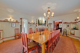 The dining room's warm color scheme was inspired by the Lilla Hytnnas dining room by Swedish artist Carl Larsson.