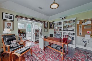 Located off of the master bedroom is an office known as the "Boat Room" with a wet bar and fridge. A door leads out to the sun porch.