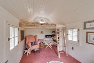 A look inside the children's playhouse with a lofted sleeping area.