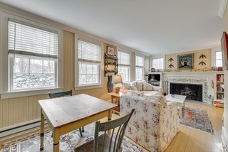 The cottage features a Great Room with a seating area with a fireplace, dining area, and kitchen. Also on the first floor is a bedroom and bathroom. A loft bedroom with window seat is located upstairs.