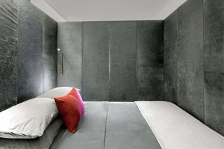 The interior of the bed container is covered with Italian cowhide dyed dark gray.