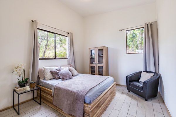 A peek into the second bedroom. All the original windows in the bedrooms were kept intact and reused. The bed frames were custom made to match the doors.