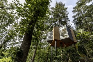 The angular exterior is sheathed in untreated larch wood, zinc, and glass.