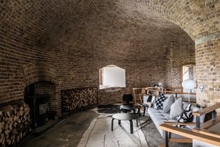 The first-floor den features a wood-burning stove. 