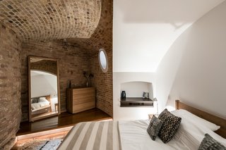 Light wells cut into the nearly 10-foot-wide masonry walls let daylight into the bedrooms, which were formerly used as storage rooms.