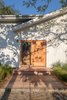 Modern home with Exterior, House Building Type, and Wood Siding Material. The Federal Bungalow is centrally located in a quiet residential neighborhood in Montauk and is a five-minute drive to the popular beach Ditch Plains. The door hardware is by Emtek and the house numbers are by Heath Ceramics. Photo 3 of Federal Bungalow